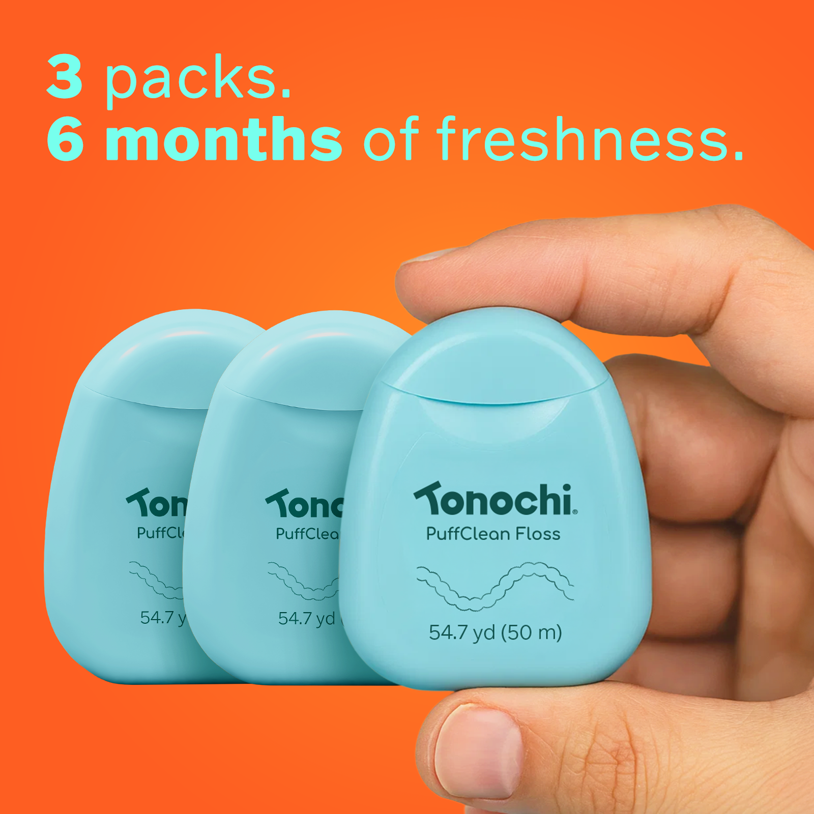 Three mint green Tonochi PuffClean floss dispensers held in a hand, providing a 6-month supply of fresh dental care.