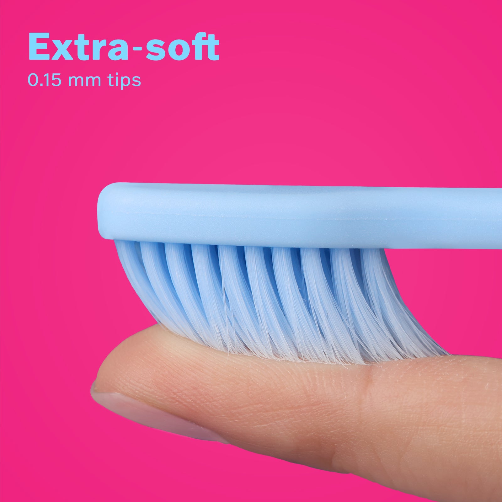Close-up of extra-soft 0.15 mm blue dental brush bristles gently pressed on a finger