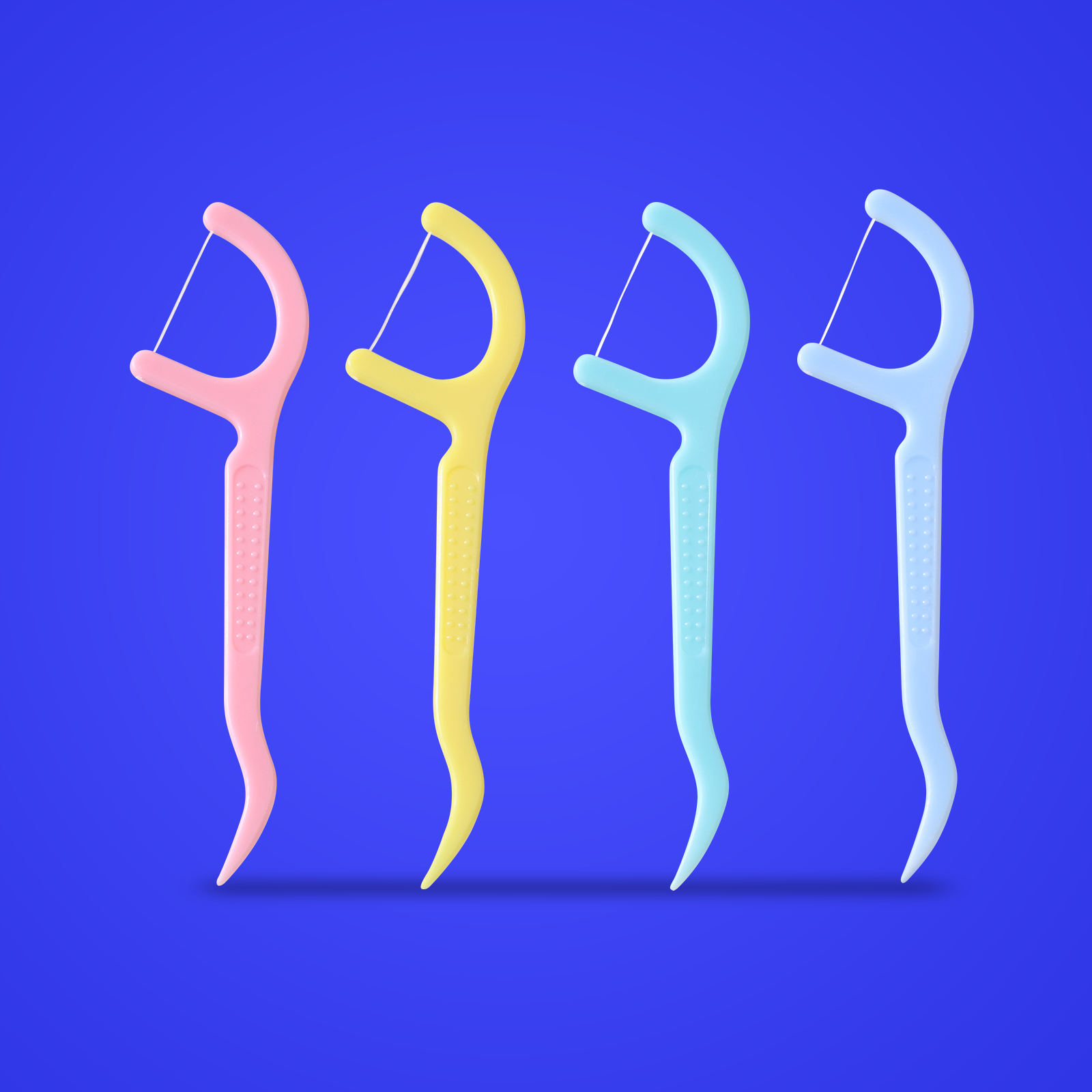 Four colorful Tonochi gum-cleaning floss picks in pink, yellow, teal, and light blue on blue background
