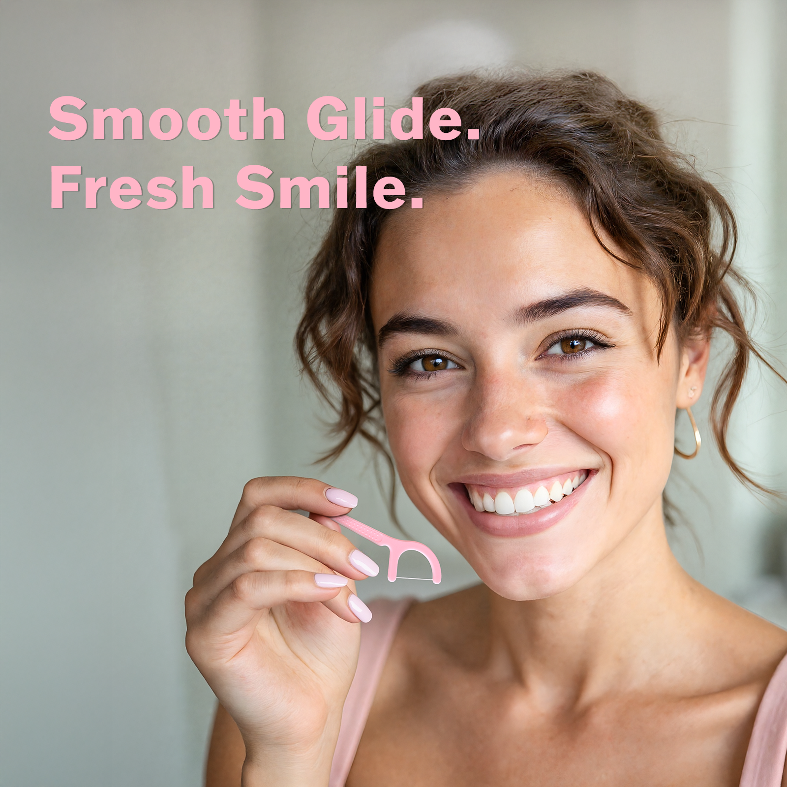 Smiling woman holding a pink dental floss pick with text Smooth Glide. Fresh Smile. for gum care