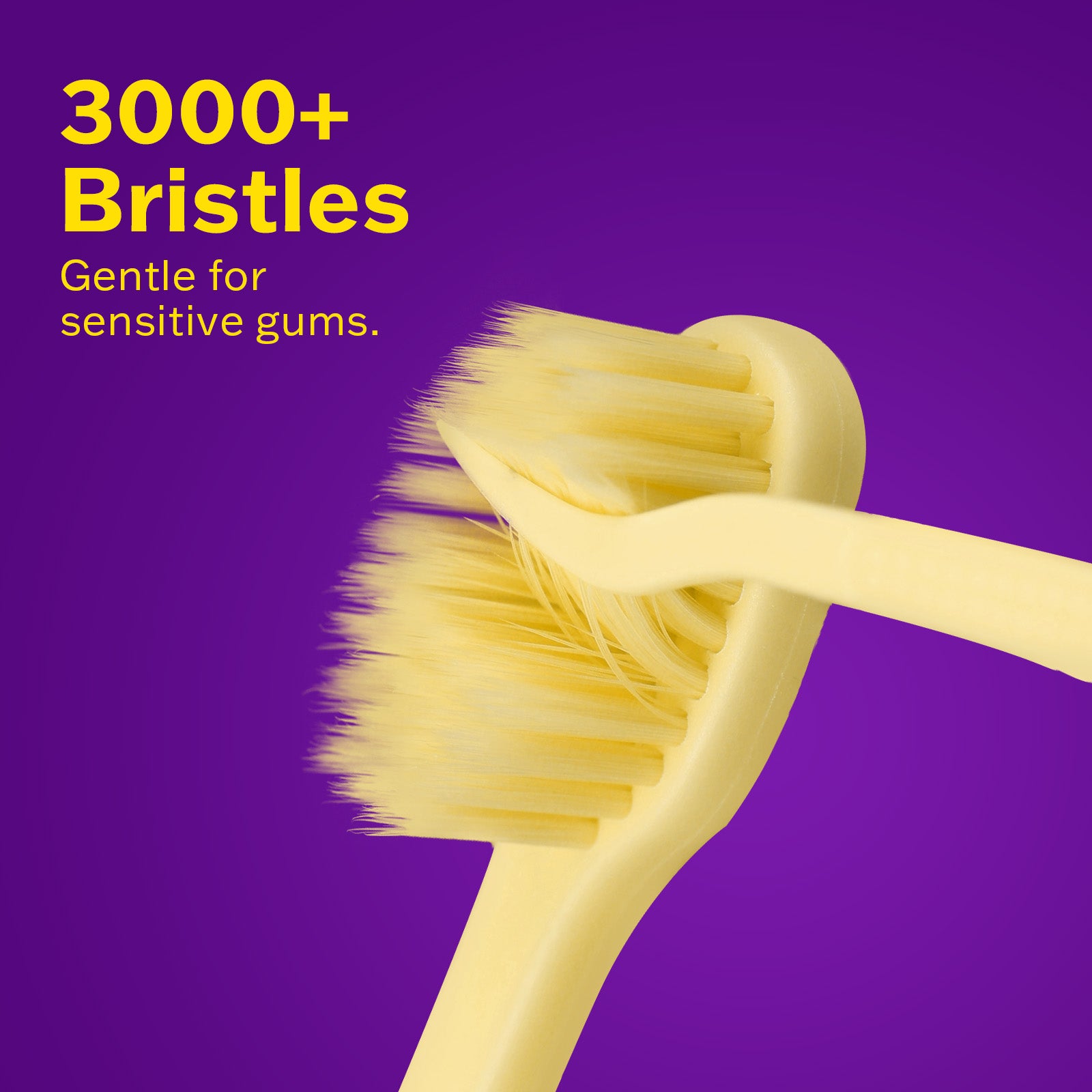 3000+ bristles toothbrush in yellow, gentle for sensitive gums against a vibrant purple background.