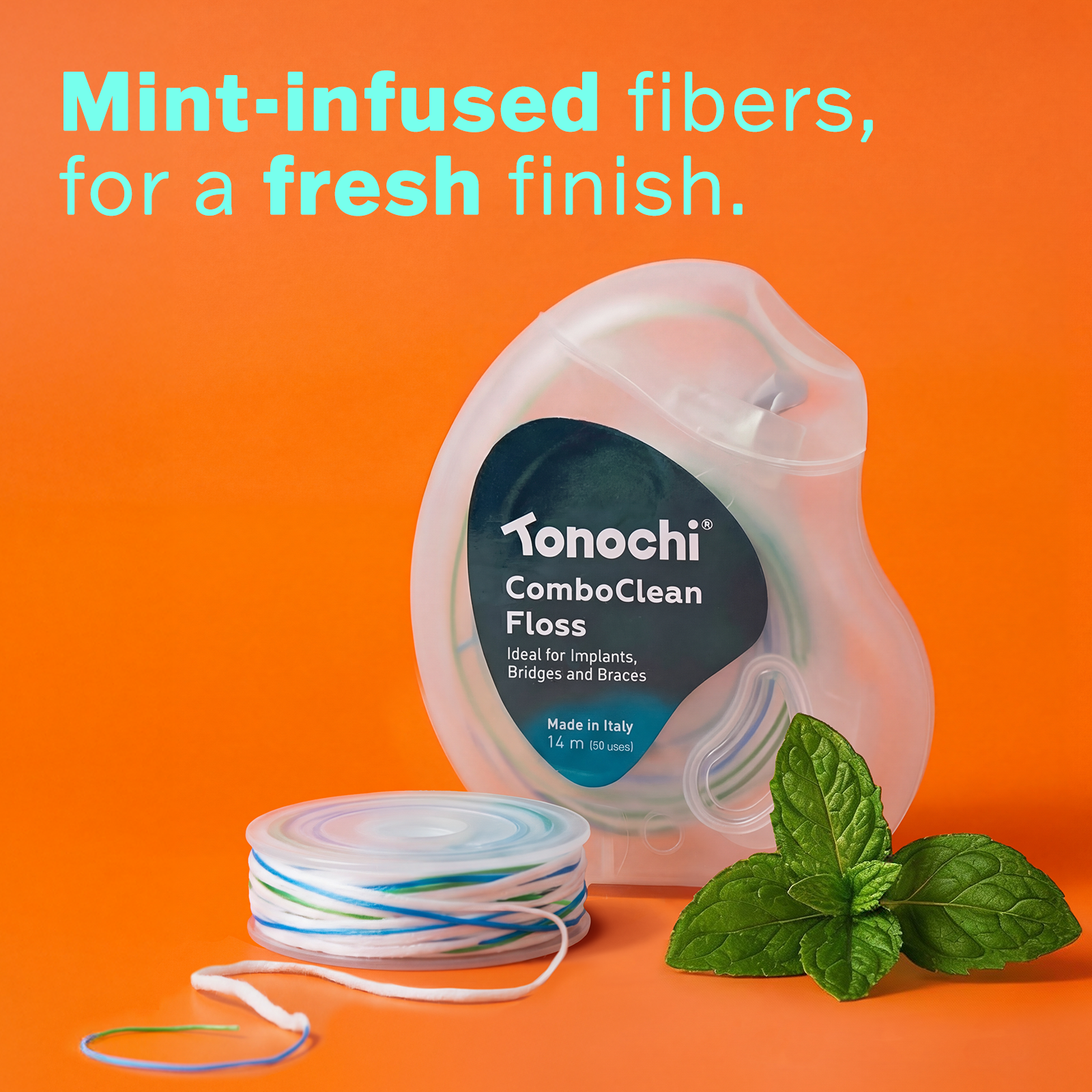 Tonochi ComboClean floss dispenser with fresh mint leaves, highlighting the refreshing mint and xylitol coating.