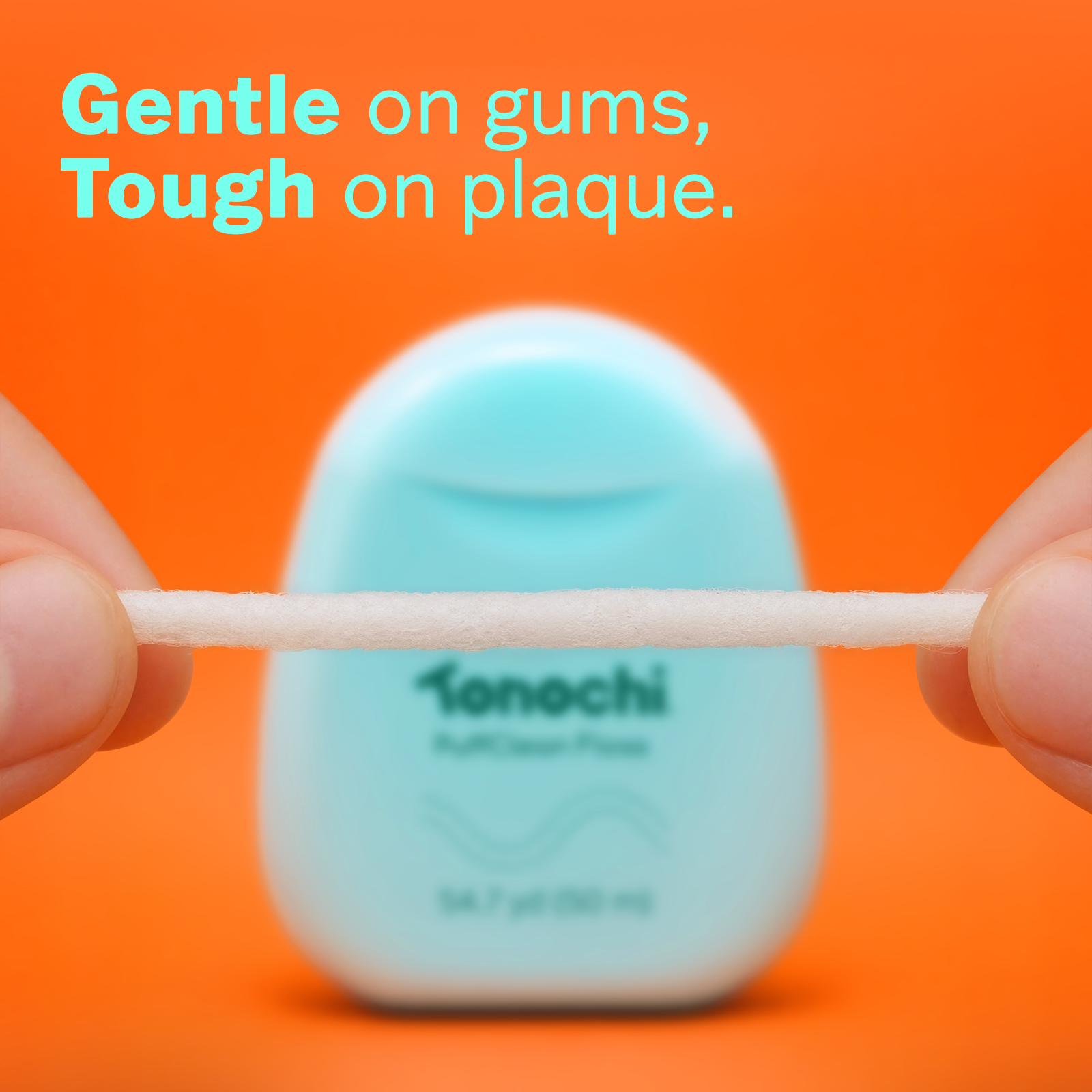 Gentle on gums, Tough on plaque, with a blue Tonochi floss container against a vibrant pink background.