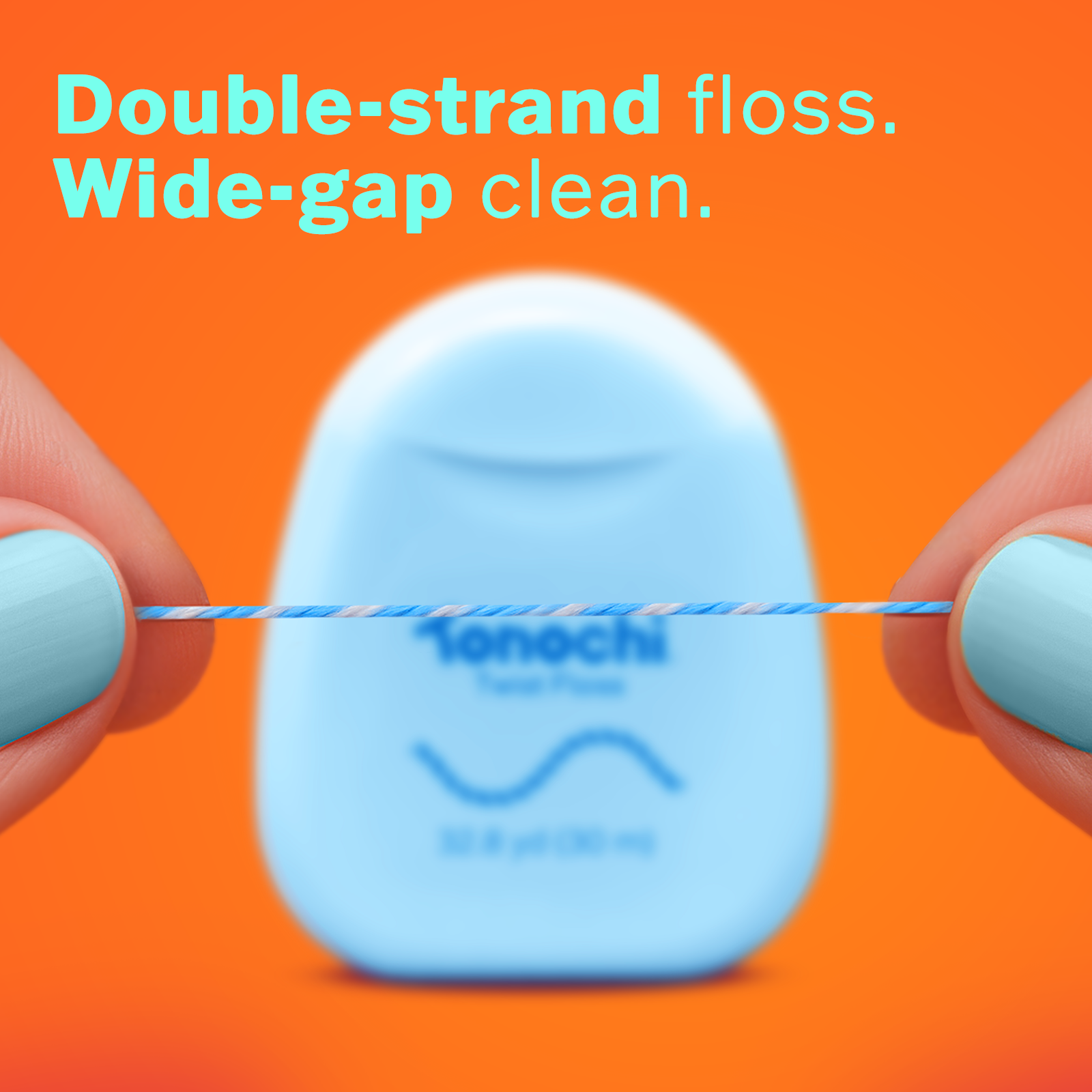 Double-strand floss in hands with light blue nails against a pink background, featuring