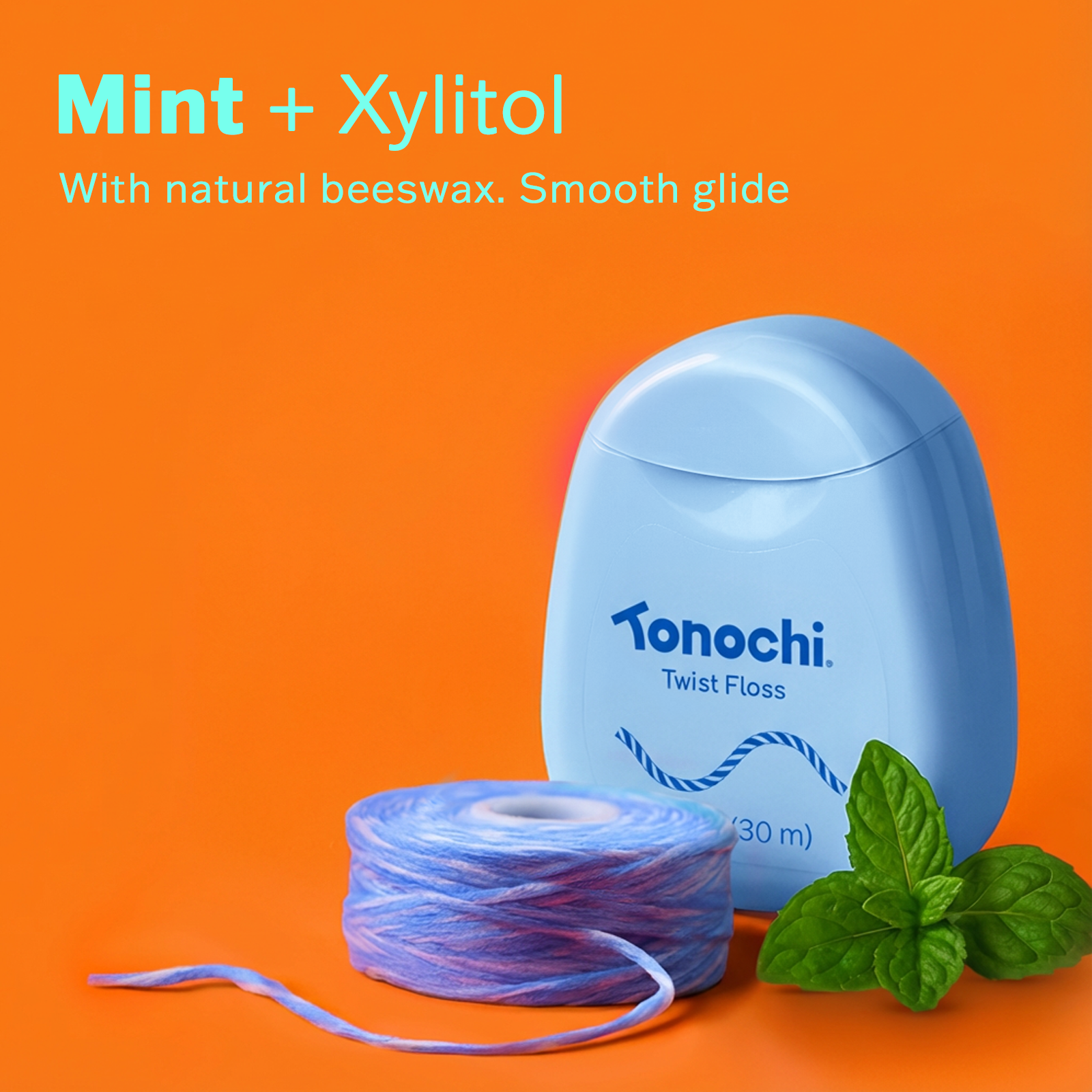 Mint + Xylitol with natural beeswax and smooth glide, featuring Tonochi Twist Floss on a vibrant pink background.