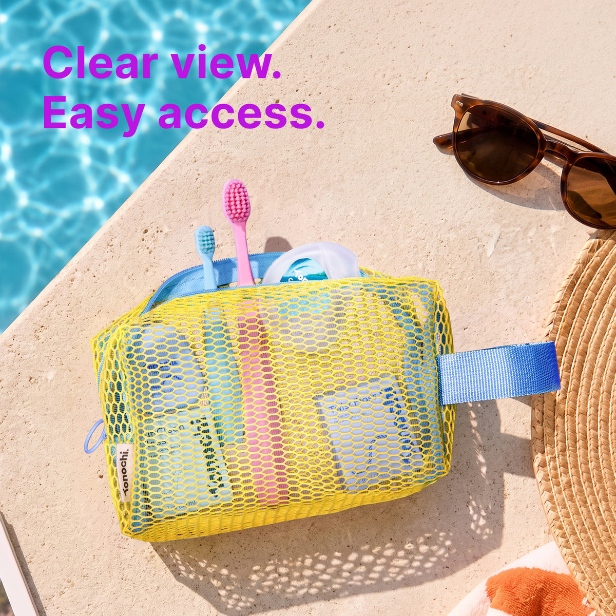 See-through yellow mesh pouch holding toothbrushes and floss by a pool