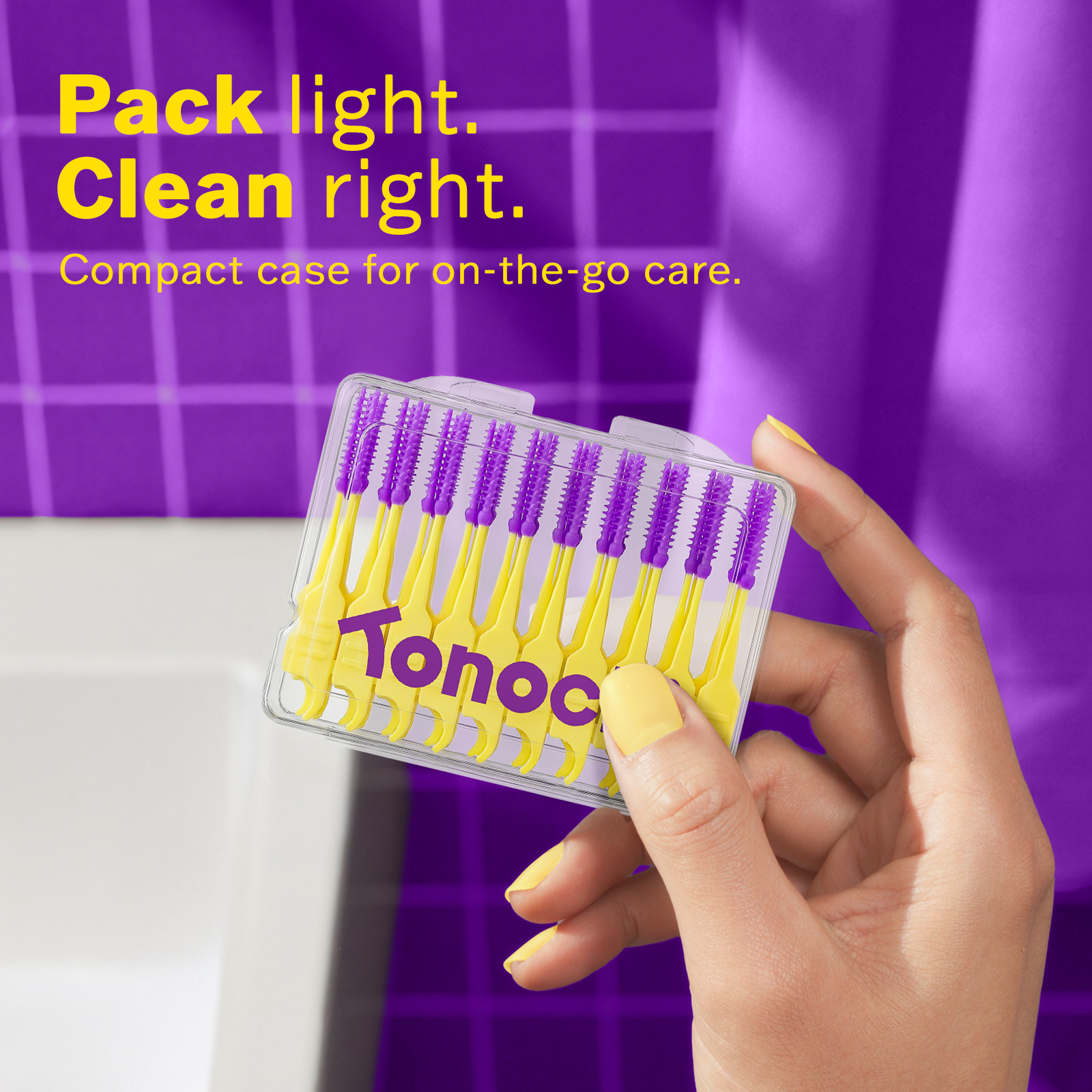Hand holding a compact case of yellow and purple cleaning brushes with 'Tonocut' branding against a purple background.