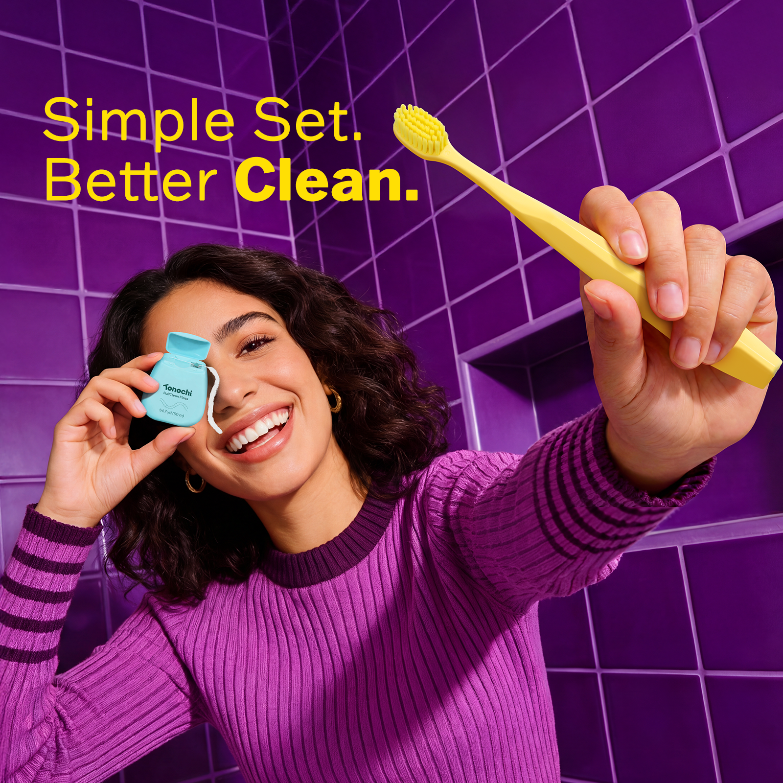 A woman in a purple sweater smiles while holding a blue dental product and a yellow toothbrush with text 