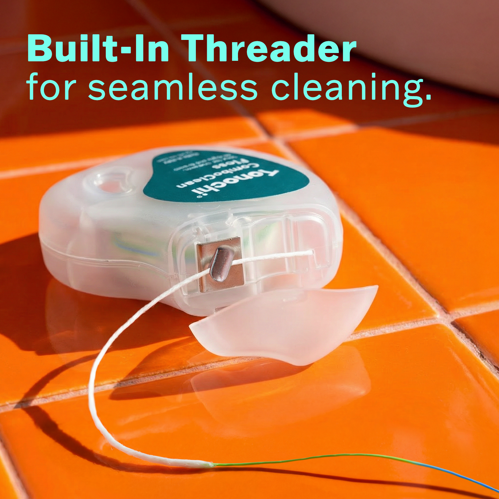 Close-up of Tonochi ComboClean dispenser showing the rigid green threader tip for easy flossing around implants.