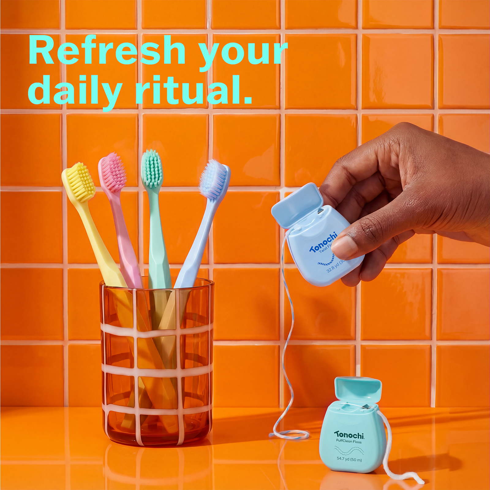 Colorful toothbrushes in a glass with the text, 