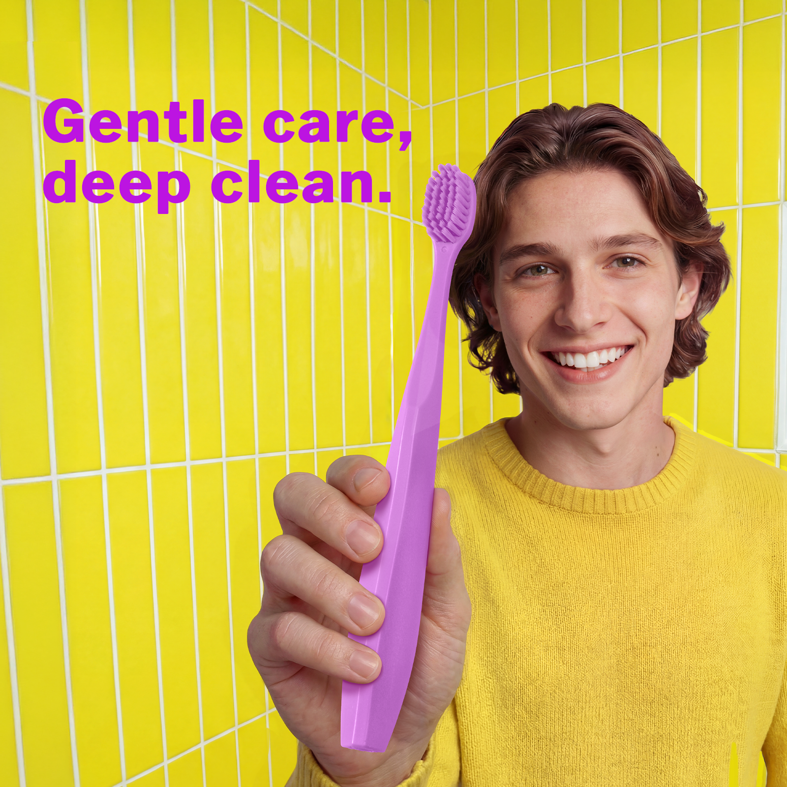 Smiling man holding a lavender Max Toothbrush with extra soft bristles, designed for a gentle clean on sensitive gums.