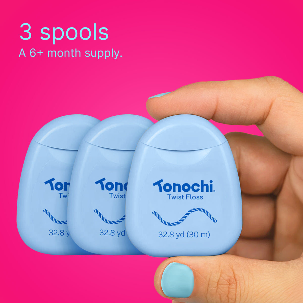 Hand holding 3 Twist floss spools: a 6+ month supply